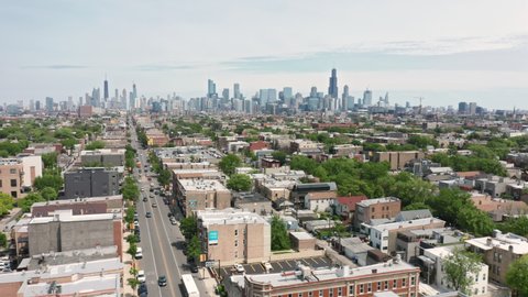 Chicago suburban, May 2021. Beautiful residential homes buildings with Chicago downtown view on background, cloudy summer day. Cinematic 4K aerial Illinois USA. Urban Chicago vacation footage