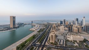 4K Day to Night aerial Time lapse video of Bahrain bay and Diplomatic area with moving traffic, Manama, Bahrain.