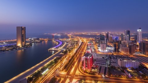 4K Day to Night aerial Time lapse video of Bahrain bay and Diplomatic area with moving traffic, Manama, Bahrain.