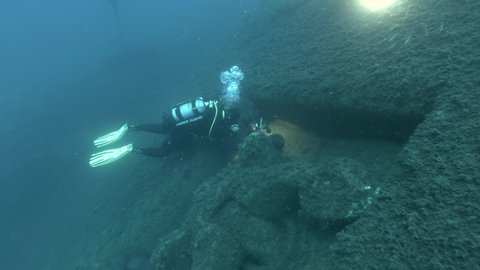 Scuba diver photographer shots ship anchor on the shipwreck Swedish ferry MS Zenobia. Wreck diving. Mediterranean sea, Cyprus