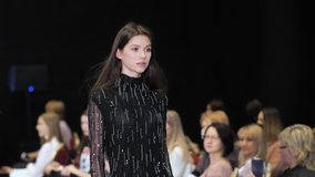 Beautiful female model walking down runway podium. Women on fashionable expo week. Haute couture catwalk, elegant people vogue. Beauty girl catwalks on fashion show stage, delicate person defile look. - Powered by Shutterstock - Get 15% off with code: PIKWIZARD15