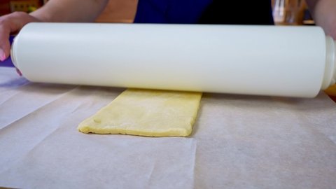Rolling out a dough. homemade baking process close up 4k.