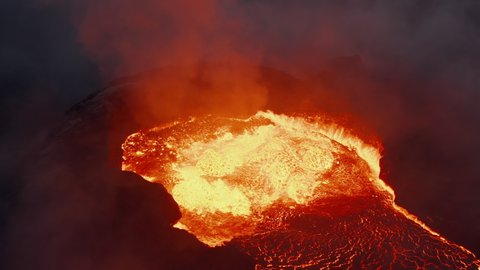 Close-up shot of magmatic material splashing out of crater. Molten lava at night. Fagradalsfjall volcano. Iceland, 2021