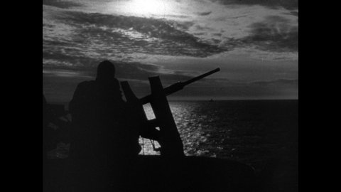 1940s: Silhouette of men on ship. Front of ship in water. Sailors at controls. Pipes in ship. Man writing. Man sleeping. Men in bunks. Door in ship. Officers at table. Gun rotating. Man signaling.