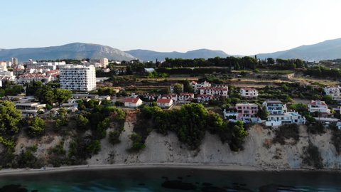 Drone view of a rocky cliff in the Croatian city of Split. Dalmatia resort region. Drone view of the sea, cottages and hotels in Croatia. Split architecture from drone. Pier with sea view