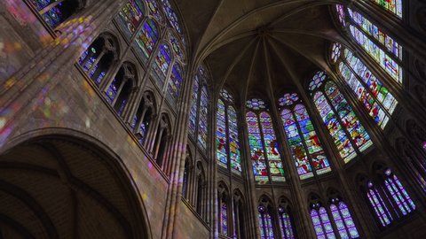Saint Denis, France - 2021 08 25: Pan over the Interior and Stained Glass of the Basilica of Saint Denis, near Paris. It was the burial place of kings and queens of France.