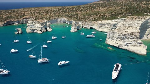 Aerial drone video of Kleftiko a beautiful scenic white volcanic rock formation bay visited by sail boats and yachts with turquoise crystal clear sea and caves, Sea Meteora of Greece, Milos island