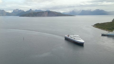 Ferry Boat Cruising At Norwegian Sea Arriving At Bognes Ferry Port From Lodingen In Nordland, Norway. - aerial