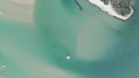 Circle drone shooting. Large white boat slow movement on dark green water to meet the sun at sunset, top view of the boat 4k video.Speed boat with people aerial view. top view.White open boat .