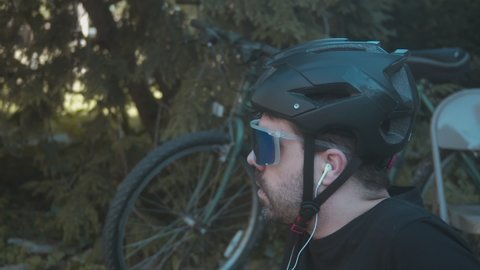 bicyclist rider with helmet next to bike