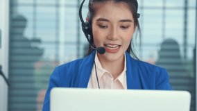 Businesswoman wearing headset working actively in office . Call center, telemarketing, customer support agent provide service on telephone video conference call.