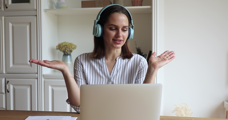 Young attractive woman in headphones use laptop pass job interview remotely, counsellor provide distance personal psychological support to client through video call. Business from home office concept Royalty-Free Stock Footage #1078695167