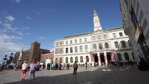 Riga, Latvia. August 2021.  people strolling in the square in front of the town hall building in the city center