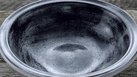 Oat flakes falling into bowl. Closeup