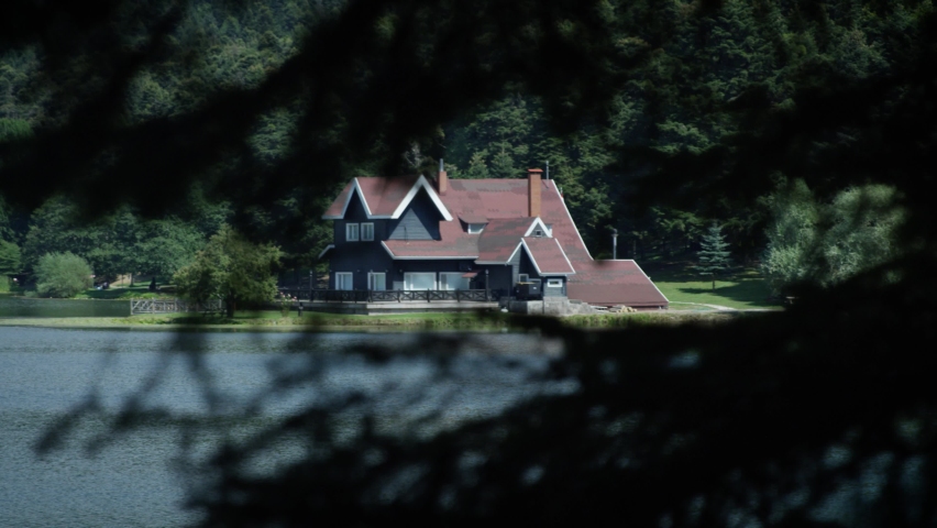 Lakeside house visible through the trees