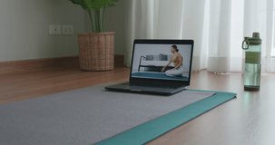 Asia serene people enjoy teach pilates zen online hobby class on laptop. Woman student remote learn body deep relax pose course on mat at home indoor happy life watch live stream sports media video.