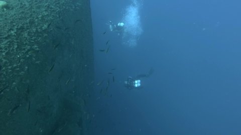 Scuba divers swims on the shipwreck Swedish ferry MS Zenobia. Wreck diving. Mediterranean sea, Cyprus