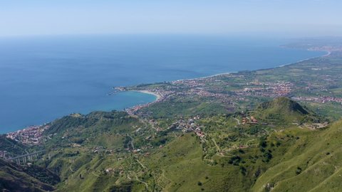 Aerial shot with drone of Monte Veneretta overlooking Taormina, Giardini Naxos, Castelmola, Etna, Ionian sea. Trekking in the mountains. Sicilian panorama. Spring in Sicily with a view of Mount Etna.