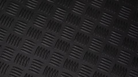 Closeup view 4k video footage of black background of textured plastic or rubber waterproof material