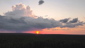 Panorama of a beautiful red evening sky with the sun over the horizon. Time lapse, dark skies at sunset. Weather, cloudy nature background. Video, footage for screensaver, transition, intro. UHD 4K.