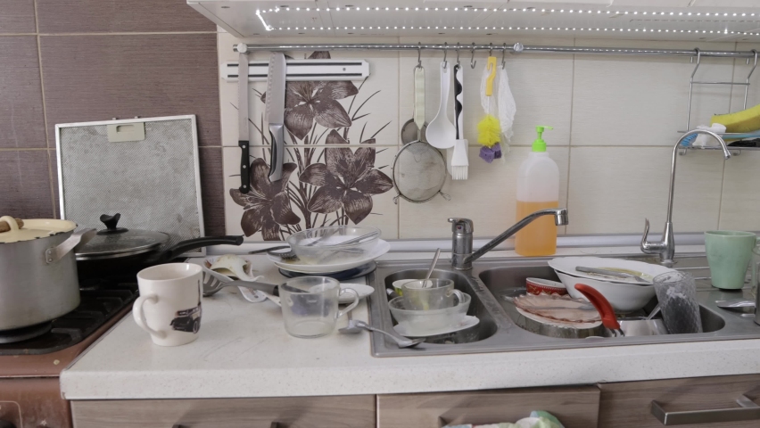 Dirty dishes in the kitchen, disconnections and interruptions in the water supply, a sloppy hostess | Shutterstock HD Video #1078731458