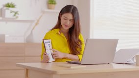 Happy young asian business woman wears yellow and headset talk to online video conference call presenting sale report with her business team at home,Business Startup Concept