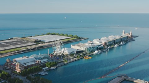 Chicago Navy Pier with clear calm blue Michigan lake on cinematic motion background. Copy space on blue horizon sky view background. Sunny summer day, 4K footage Chicago Illinois USA aerial footage