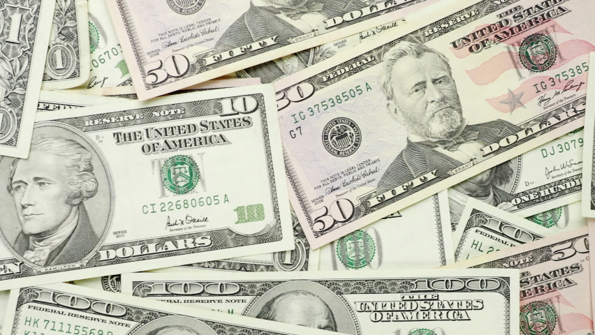 A money pile of various US banknotes in 4K VIDEO. Cash of dollar bills, paper currency background. Royalty-Free Stock Footage #1078739312