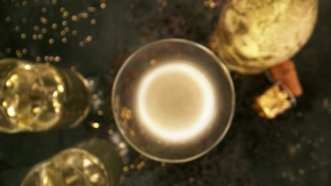 Super slow motion of camera movement into glass of champagne. Unique angle with underwater macro lens. Concept of celebration and success. Filmed on high speed cinema camera, 1000 fps