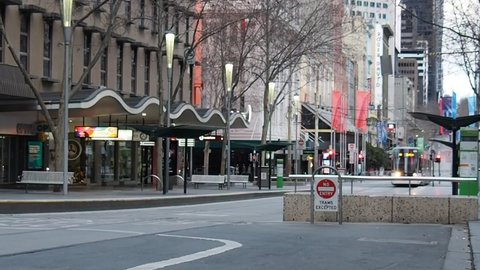 MELBOURNE, AUSTRALIA - Aug 21, 2021: Empty Melboune city streets at night under coronavirus lockdown curfew  Flinders Street Station intersection in CBD city during covid-19 pandemic 2021