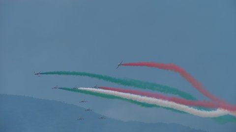 Maribor Slovenia AUGUST, 15, 2021 Military aircraft perform rolls in pairs in formation. Perfect teamwork highlighted by the Italian flag. Frecce Tricolori Italian Aerobatic Team on Aermacchi MB-339