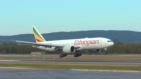 Oslo Airport Norway - September 4 2021: arrival boeing 777 passenger airplane ethiopian airlines landing touchdown slow motion