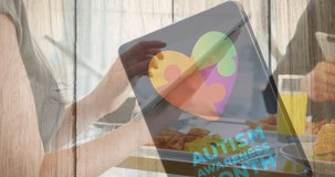Animation of colourful puzzle pieces and autism text over business people using digital devices. autism, learning difficulties, support and awareness concept digitally generated video.