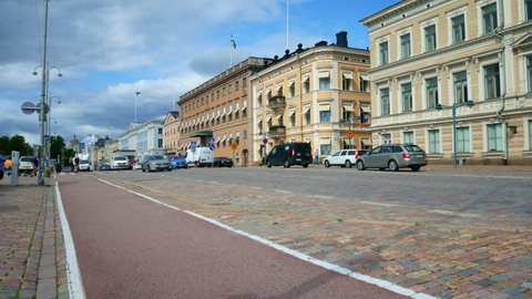 Helsinki, Finland - August 20, 2021: Beautiful Helsinki cityscape. Concept of different modes of transportations in a big city- cars, bikes, electric push scooters etc.