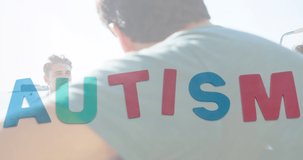 Animation of colourful puzzle pieces and autism text over happy friends at summer beach party. autism, learning difficulties, support and awareness concept digitally generated video.