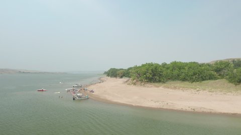 Saskatchewan Landing Provincial Park With Boats And Tourists On Sandy Shore Of Lake Diefenbaker In Saskatchewan, Canada. - Aerial