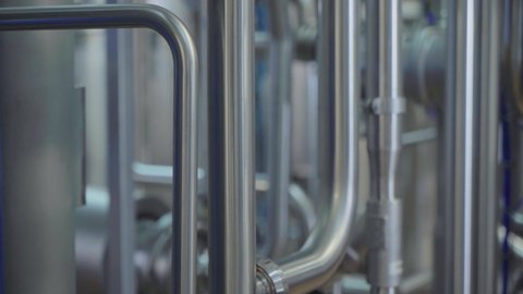 Close Up Of A Dairy Factory Industrial Equipment With Metal Tubes. Factory Machinery With Industrial Tubes At A Dairy Food Production Plant. Factory Industrial Tubes Used In A Manufacturing Process.
