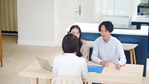 Young asian couple and woman meeting int he modern house. Salespeople of real estate.
