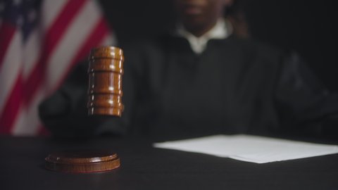 Female judge striking gavel after final verdict, american justice system