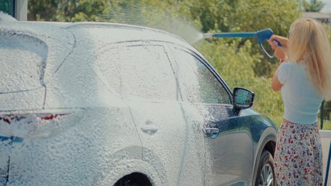 Dirty Car Cleaning And Protection With Active Foam.Clean Water Spray Pressure.Woman Washing Car On Wash Self-Service.Washes Automobile Active Foam And Osmosis Water.Car Wash And Waxing Vehicle