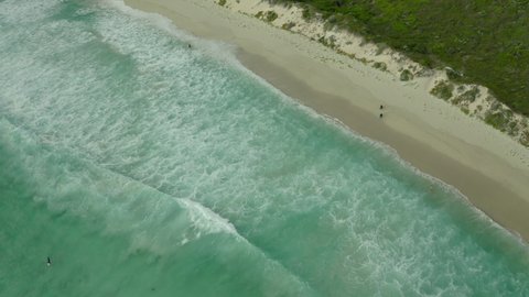 Aerial Shot Of Surfers Exploring Beach During Vacation, Drone Flying Over Sea - Western Australia, Australia