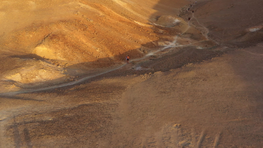 Aerial Forward Shot Of People Exploring Dramatic Desert Landscape During Vacation - Shaharut, Israel