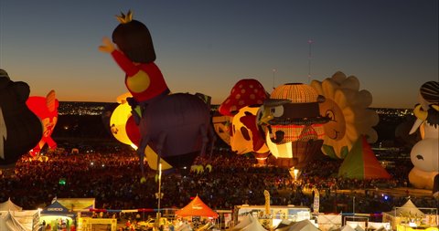 Time Lapse Lockdown Shot Of Animal And Human Representation Hot Air Balloons In Festival During Night - Albuquerque, New Mexico