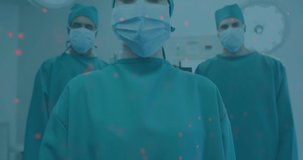 Animation of data processing over masked male and female surgeons in operating theatre. medical services, research and science concept digitally generated video.