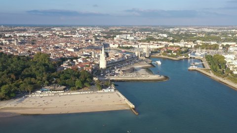 France, La Rochelle, long drone aerial shot starting from Concurrence beach to the Old Port. Flight above the Lanter tower, Tour de la Chaine and Saint-Nicolas tower.
