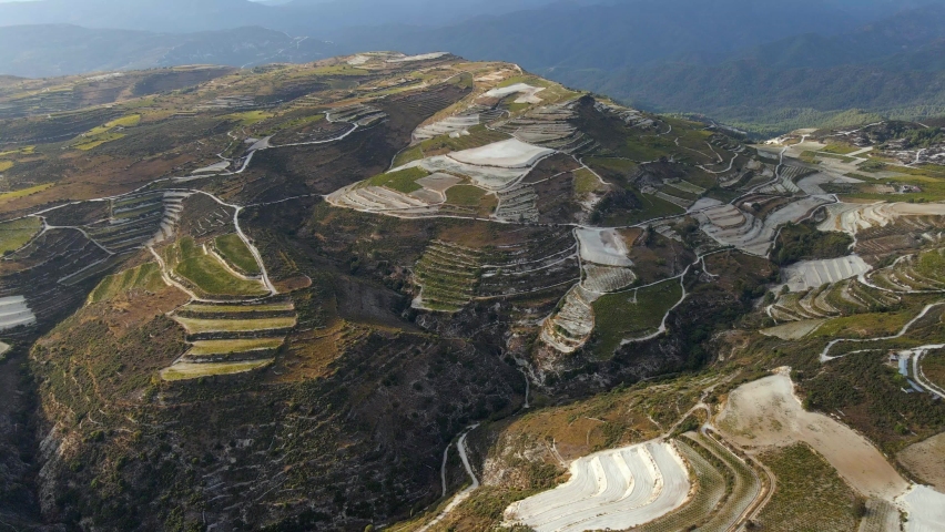 Aerial view overlooking terraces and fields, in the highlands of Cyprus - circling, drone shot
