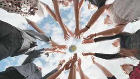Female student girls standing in a circle toss the world globe up. - Powered by Shutterstock - Get 15% off with code: PIKWIZARD15