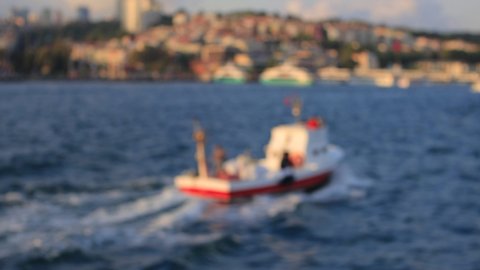 Blur texture background for design. Out of focus view of the sea and ships sailing on the water. View of the Sea of ​​Marmara and the Bosphorus in Istanbul city on a sunny evening.