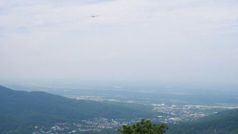  Aerial view of flying motorless glider low angle view of plane  - calm blue sky and beautiful panorama of Baden-Baden city