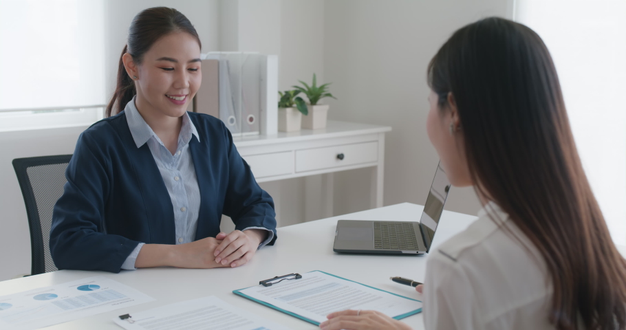 Close-up hand asia people woman fill rent loan form write legal debt letter at lawyer home office. Happy female life buy or sell new house deal from real estate sale agent. Tax advice talk and smile. Royalty-Free Stock Footage #1078814609
